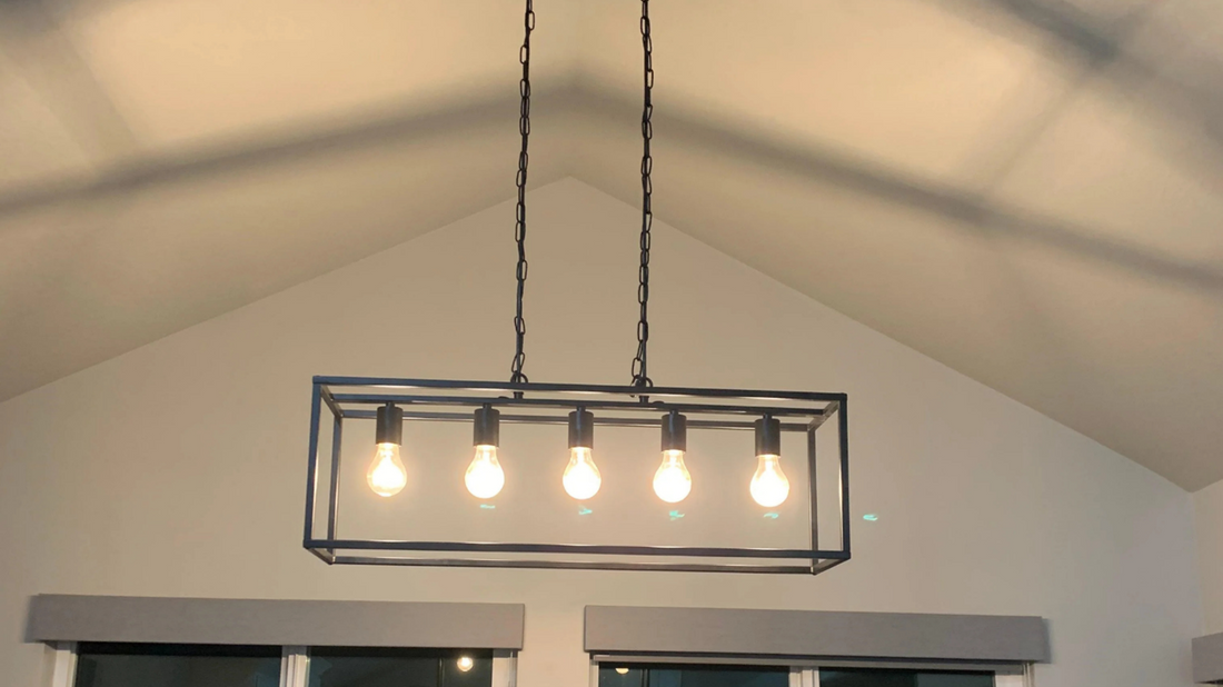 Coolilumi rectangular ceiling light fixture with five glowing bulbs hanging in a modern kitchen space