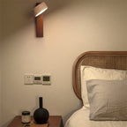 Coolilumi wooden wall lamp with travertine base, cozy bedroom lighting fixture.