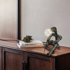 Bronze Pipe Robot Table Lamp on Wooden Console Table with Books & Dried Plant | Industrial Steampunk Decor for Living Room, Entryway or Modern Home Office